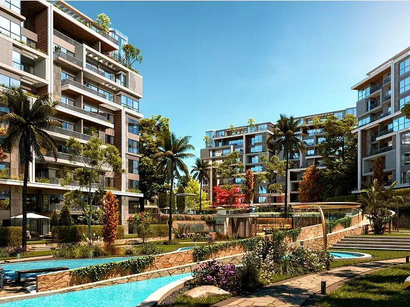 Najm in 6th Settlement — a landscaped lagoon, gardens and steps between residential buildings